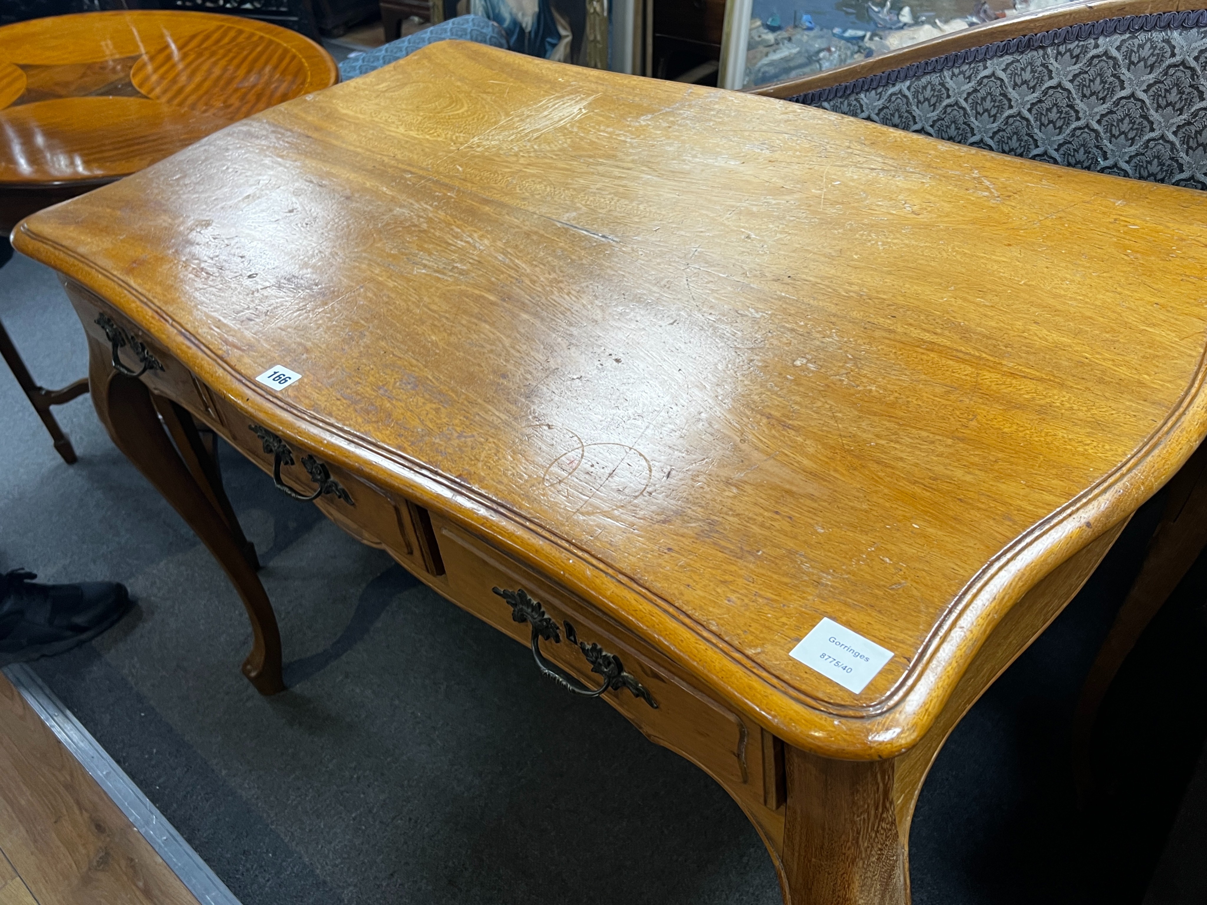 An early 20th century French serpentine three drawer side table, width 108cm, depth 62cm, height 76cm